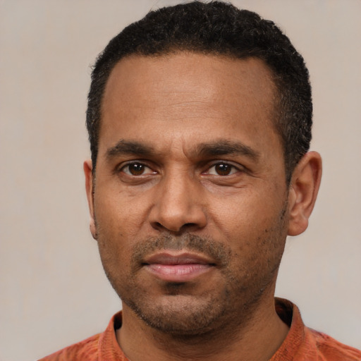 Neutral latino adult male with short  black hair and brown eyes