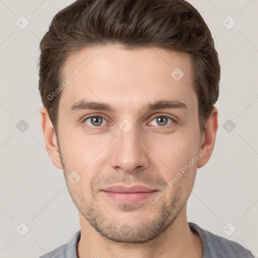 Joyful white young-adult male with short  brown hair and grey eyes