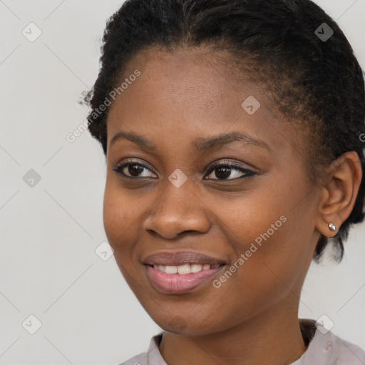 Joyful black young-adult female with short  brown hair and brown eyes