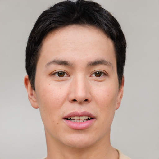 Joyful asian young-adult male with short  brown hair and brown eyes