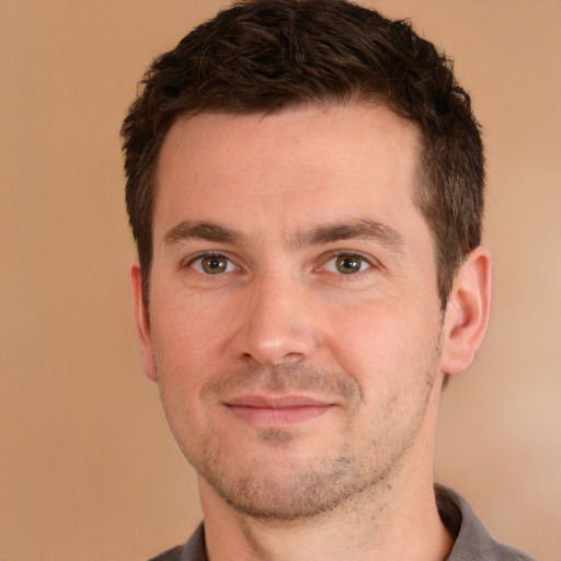 Joyful white young-adult male with short  brown hair and brown eyes