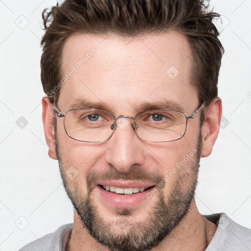 Joyful white adult male with short  brown hair and grey eyes