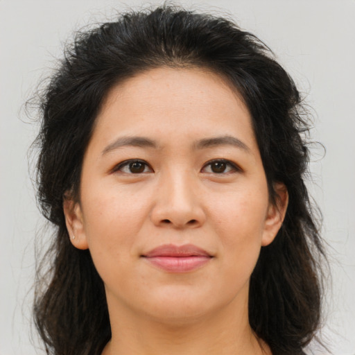 Joyful asian young-adult female with long  brown hair and brown eyes