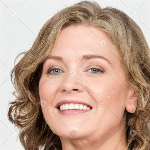 Joyful white adult female with medium  brown hair and blue eyes