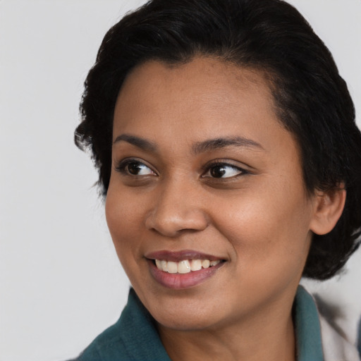 Joyful black young-adult female with medium  black hair and brown eyes