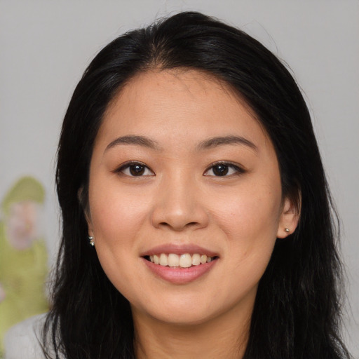 Joyful white young-adult female with long  black hair and brown eyes