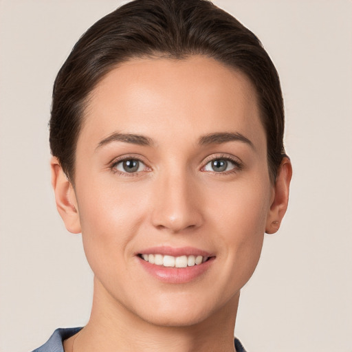 Joyful white young-adult female with short  brown hair and grey eyes