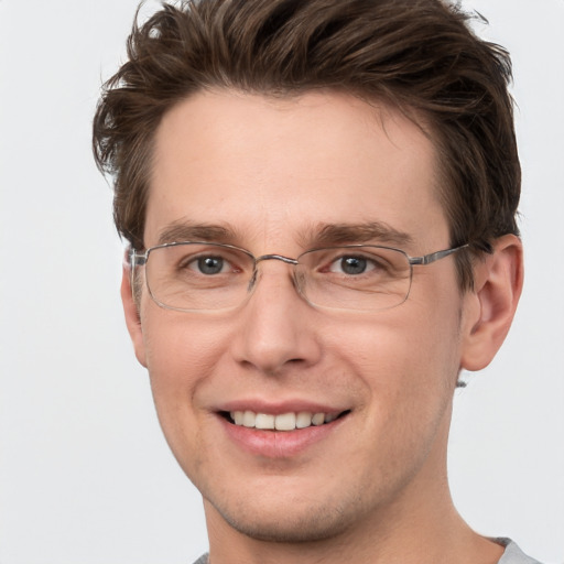 Joyful white adult male with short  brown hair and grey eyes