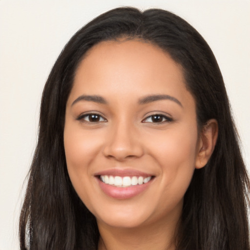 Joyful latino young-adult female with long  brown hair and brown eyes