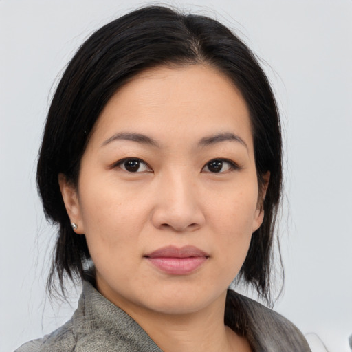 Joyful asian young-adult female with medium  black hair and brown eyes