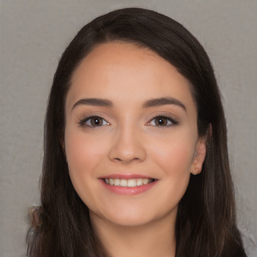 Joyful white young-adult female with long  black hair and brown eyes