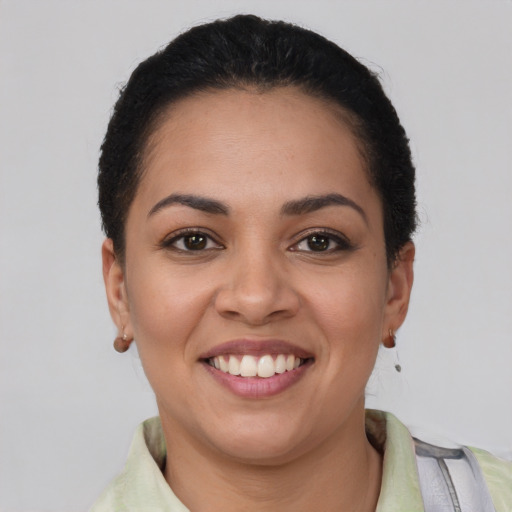 Joyful latino young-adult female with short  brown hair and brown eyes