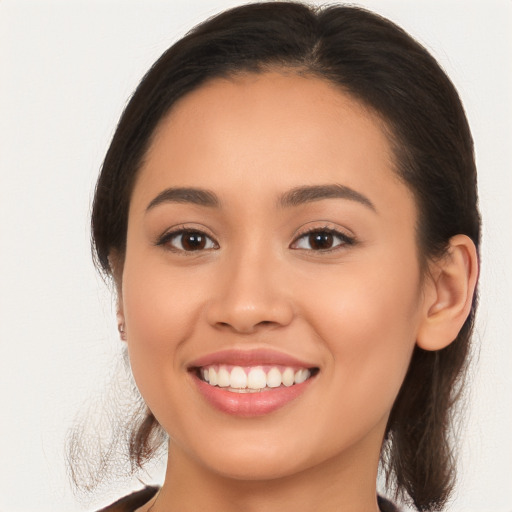 Joyful white young-adult female with long  brown hair and brown eyes