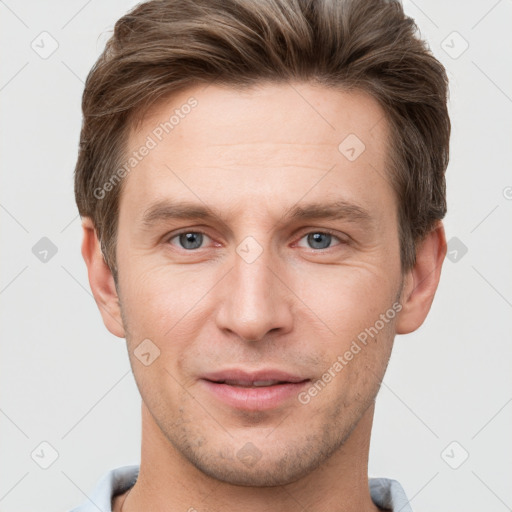 Joyful white young-adult male with short  brown hair and grey eyes