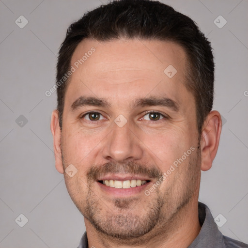 Joyful white adult male with short  brown hair and brown eyes