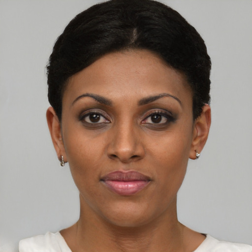Joyful black young-adult female with short  black hair and brown eyes