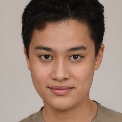 Joyful asian young-adult male with short  brown hair and brown eyes