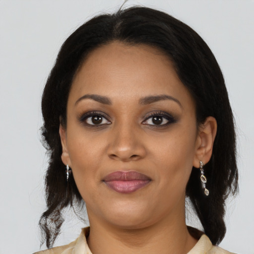 Joyful black young-adult female with medium  brown hair and brown eyes
