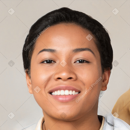 Joyful latino young-adult female with short  black hair and brown eyes