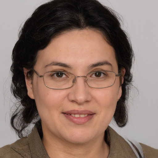 Joyful white adult female with medium  brown hair and brown eyes