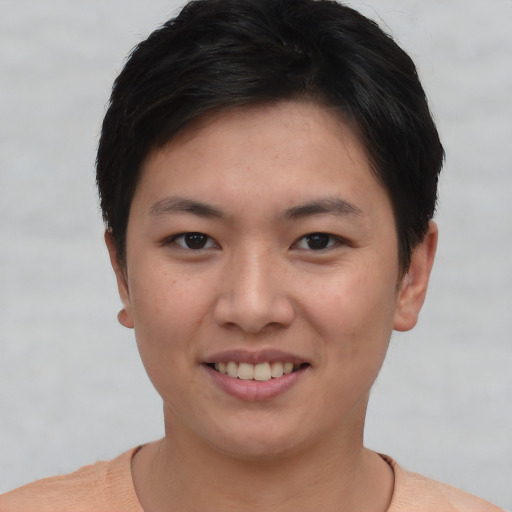 Joyful asian young-adult female with short  brown hair and brown eyes