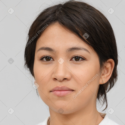 Joyful asian young-adult female with medium  brown hair and brown eyes