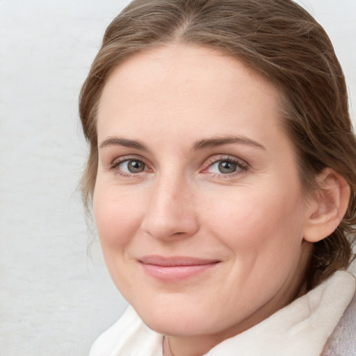 Joyful white young-adult female with medium  brown hair and blue eyes