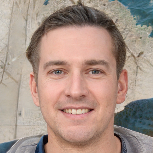 Joyful white adult male with short  brown hair and brown eyes