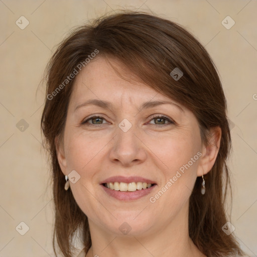 Joyful white adult female with medium  brown hair and grey eyes