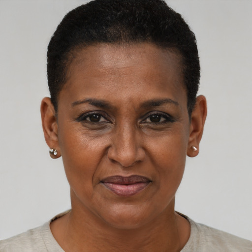 Joyful black adult female with short  brown hair and brown eyes