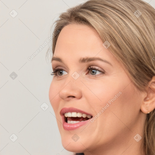 Joyful white young-adult female with long  brown hair and grey eyes