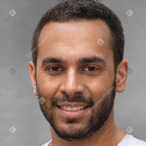 Joyful white young-adult male with short  black hair and brown eyes