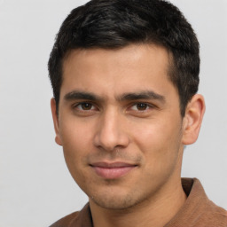 Joyful latino young-adult male with short  brown hair and brown eyes