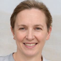 Joyful white adult female with short  brown hair and grey eyes