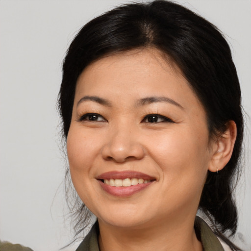 Joyful asian young-adult female with medium  brown hair and brown eyes