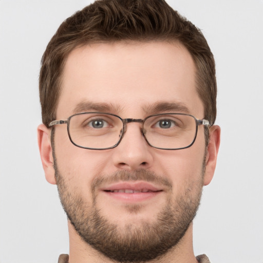 Joyful white young-adult male with short  brown hair and grey eyes