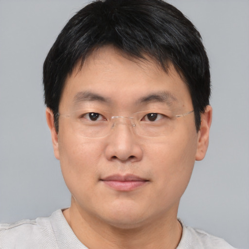 Joyful asian adult male with short  brown hair and brown eyes