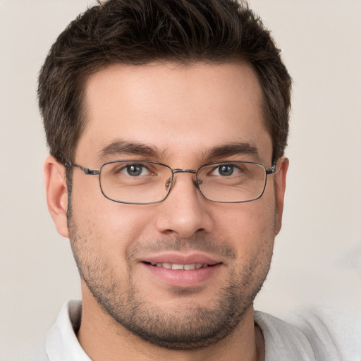 Joyful white young-adult male with short  brown hair and brown eyes