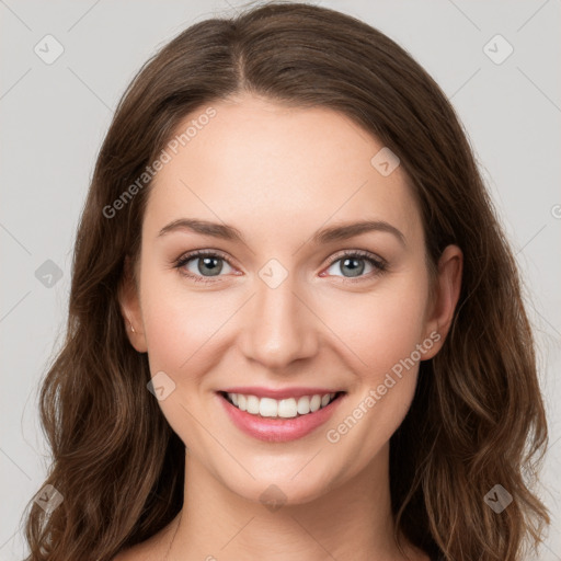 Joyful white young-adult female with long  brown hair and green eyes