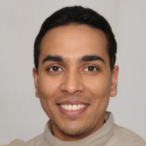 Joyful latino young-adult male with short  black hair and brown eyes