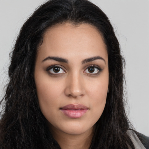 Joyful latino young-adult female with long  brown hair and brown eyes