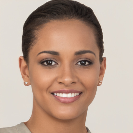 Joyful latino young-adult female with short  brown hair and brown eyes