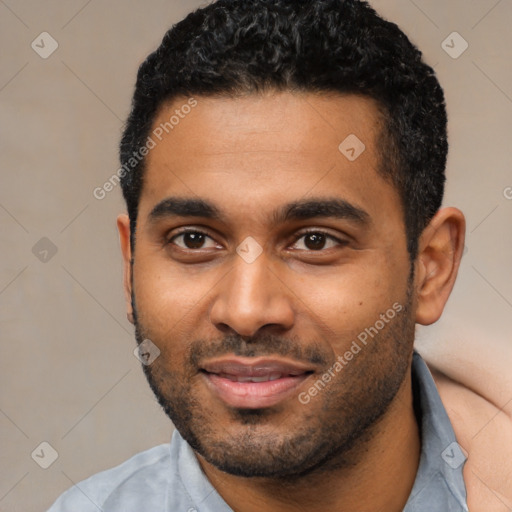 Joyful black young-adult male with short  black hair and brown eyes