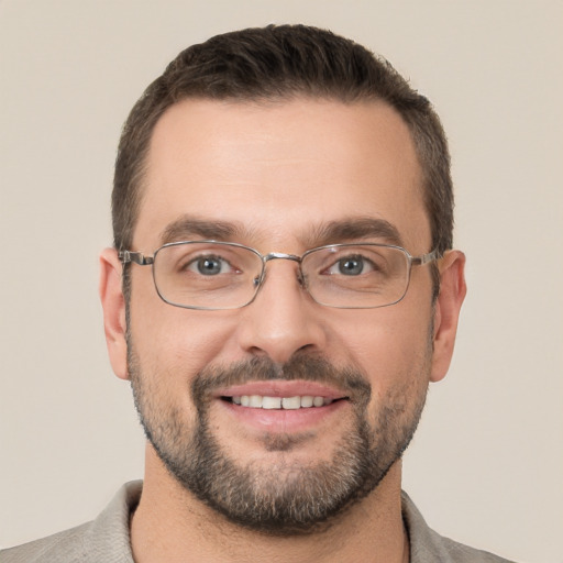 Joyful white adult male with short  brown hair and brown eyes