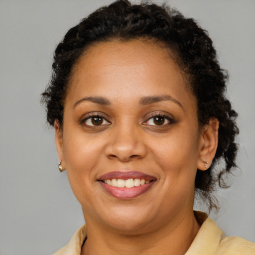 Joyful latino young-adult female with short  brown hair and brown eyes