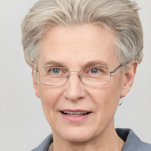 Joyful white middle-aged female with short  gray hair and blue eyes