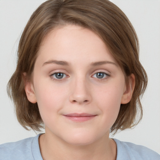 Joyful white young-adult female with medium  brown hair and blue eyes