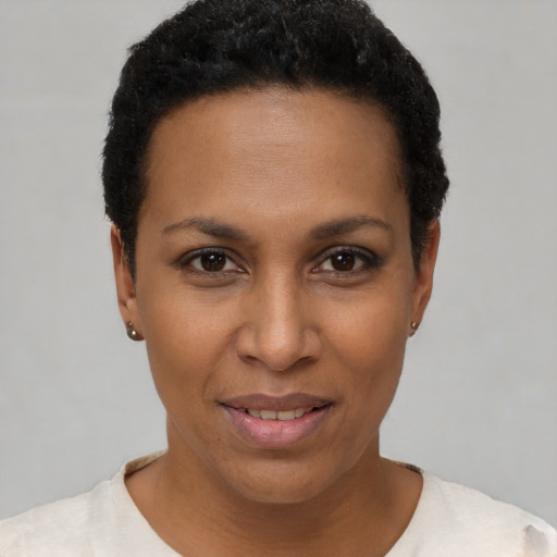 Joyful black young-adult female with short  black hair and brown eyes