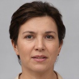 Joyful white adult female with short  brown hair and brown eyes