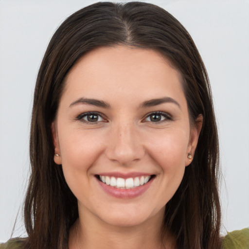 Joyful white young-adult female with long  brown hair and brown eyes